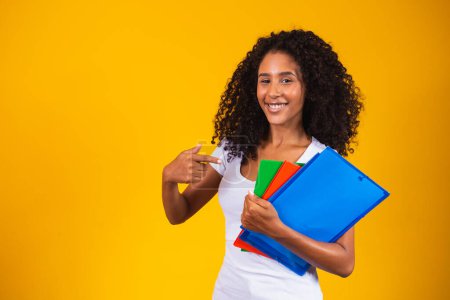Photo for Young African-American student in yellow background - Royalty Free Image