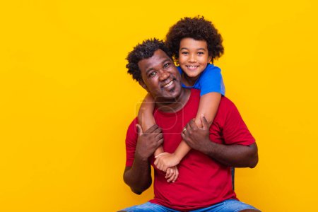 Photo for Father and son on yellow background. Children's Day or Father's Day Concept - Royalty Free Image