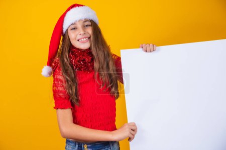 Photo for Happy little girl at Christmas with empty blank poster aside with space for text. - Royalty Free Image