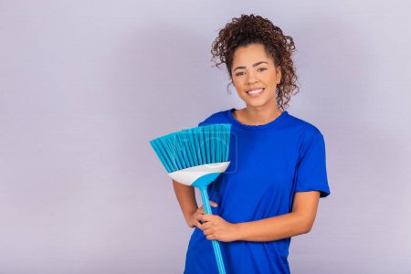 Photo for Housewife woman. Cleaner. Young man holding broom on white background with free space for text. - Royalty Free Image