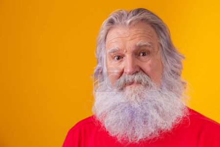Photo for Closeup of an elderly Caucasian bearded man on yellow background. - Royalty Free Image