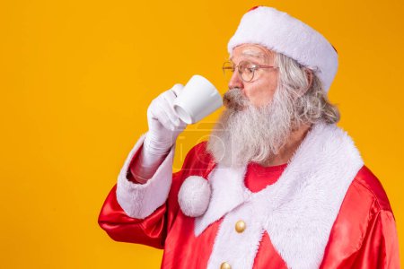 Photo for Santa Claus having a cup of coffee or tea - Royalty Free Image