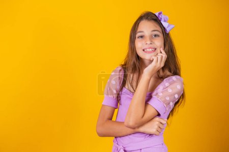 Photo for Portrait of a happy smiling child girl in yellow background. - Royalty Free Image