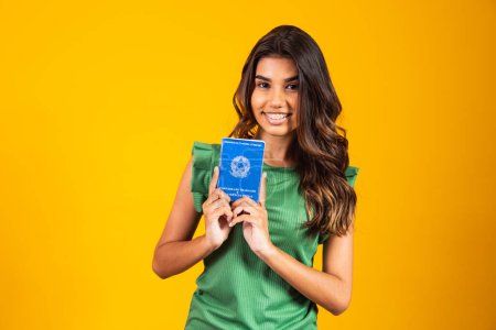 Photo for Young girl holding the brazilian work card - Royalty Free Image