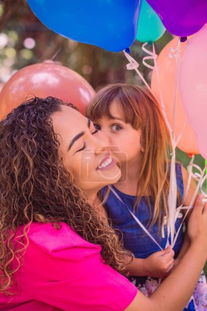 Photo for Happy mother and daughter in the park with balloons. - Royalty Free Image