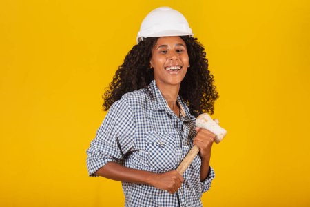 Photo for Female engineer holding a sledgehammer - Royalty Free Image