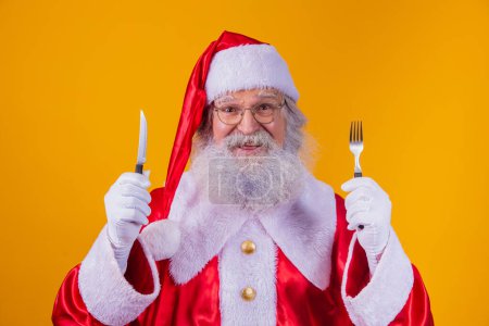 Foto de Santa Claus sosteniendo un cuchillo y tenedor - Imagen libre de derechos