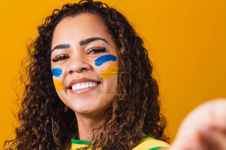 Photo for Brazilian fan with painted face taking a selfie - Royalty Free Image