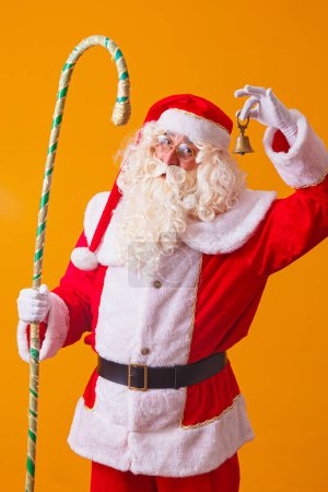 Photo for Santa Claus with bell on yellow background. beautiful Santa Claus - Royalty Free Image