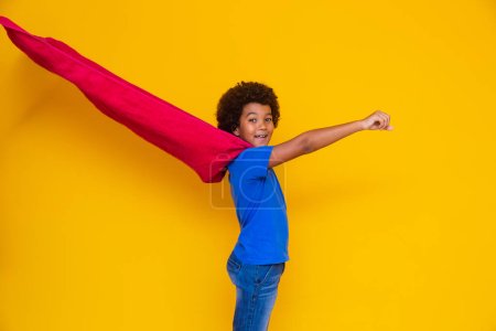 Photo for Portrait of a young, mixed race boy dressed as a superhero. Black baby in super hero costume. The winner and success concept. - Royalty Free Image