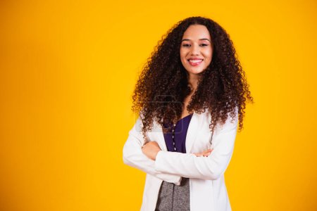 Photo for Young afro business woman with arms crossed smiling looking at camera. - Royalty Free Image