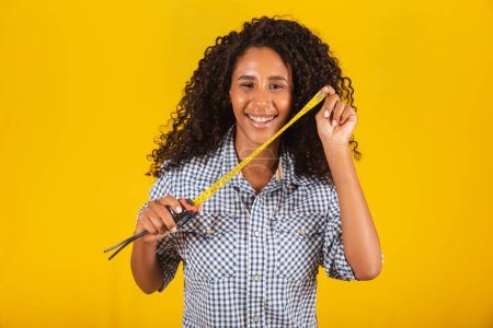 Photo for A young female holding a tape measure - Royalty Free Image