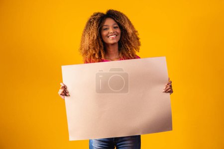 Photo for Woman shows empty board. Advertising board. Black friday. Advertising. Smiling woman holds empty advertising banner. Ready for your text. Sale and discount. Season sales. - Royalty Free Image