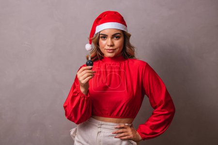 Photo for Christmas girl in santa hat holding auto keys. Isolated. - Royalty Free Image