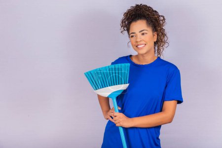 Photo for Housewife woman. Cleaner. Young man holding broom on white background with free space for text. - Royalty Free Image