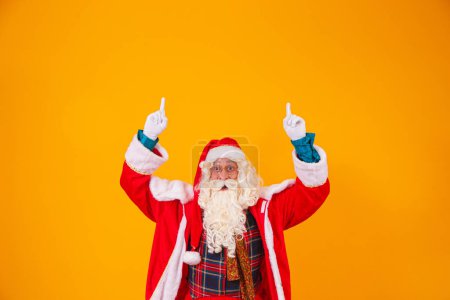 Photo for Santa Claus pointing up in space for text - Royalty Free Image