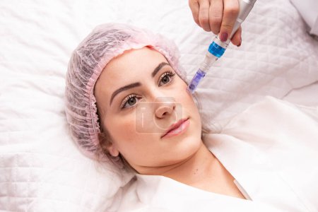 Photo for Beautiful woman receiving microneedling rejuvenation treatment. Mesotherapy. - Royalty Free Image