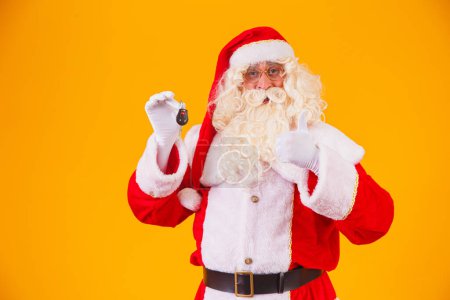 Photo for Santa Claus carries car keys in a special year-end promotion - Royalty Free Image