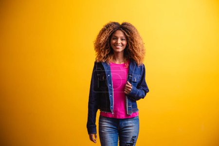 Photo for African student woman smiling on yellow background. - Royalty Free Image