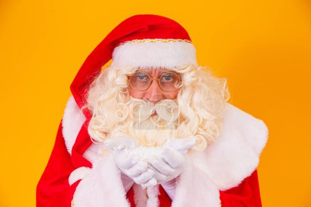 Photo for Merry Christmas and Happy Holidays! Santa Claus blows snow. - Royalty Free Image