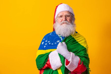 Photo for Santa Claus is a fan of Brazil. Santa Claus fan of the Brazilian team. Sports championship. Santa Claus with the Brazilian flag. Football match. - Royalty Free Image