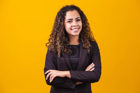 Photo for Afro Business Woman. Confident black woman in suit posing with folded arms on yellow background, horizontal banner, wide long shot, panorama - Royalty Free Image
