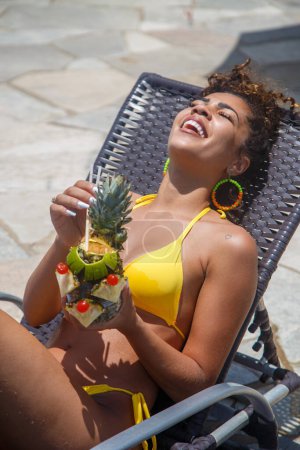 Photo for Young woman on vacation having a pineapple drink - Royalty Free Image