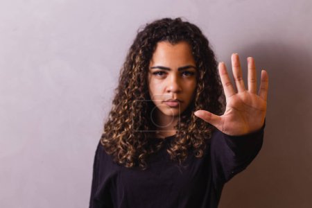 Photo for Confident black woman protesting against racial discrimination isolated on yellow background - Young diverse african woman showing black lives matter gesture - stop racism, human rights concept - Royalty Free Image
