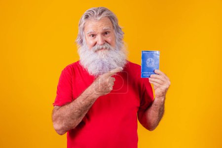 Photo for Senior bearded teenager holding a Brazilian work card - Royalty Free Image