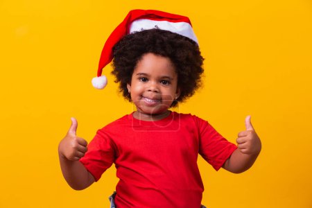 Photo for Little afro girl child with Santa Claus hat. - Royalty Free Image