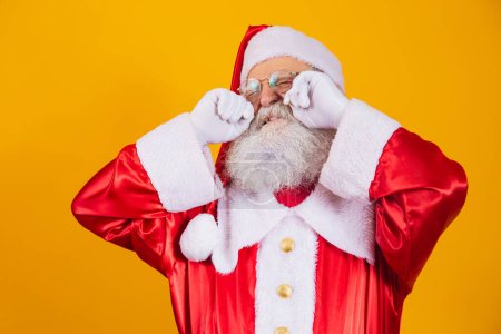 Photo for Santa Claus crying with his hands in his eyes. - Royalty Free Image