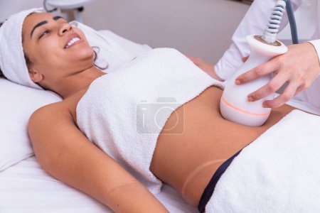 Photo for Woman doing lipocavitation in the clinic - Royalty Free Image