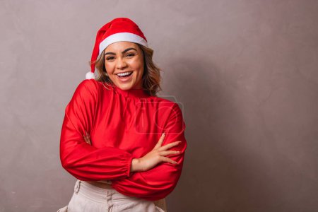 Photo for Close-up shot of a beautiful young woman with Santa hat and arms crossed. Merry Christmas - Royalty Free Image