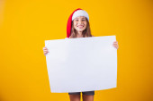 happy little girl at Christmas with a blank empty white poster Poster #655795758