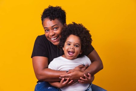 Photo for Happy mother's day! Adorable sweet afro-american mother with cute little daugh. Older mother with her daughter on yellow background. - Royalty Free Image