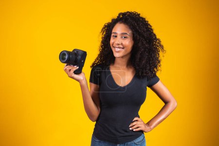 Photo for Young woman taking photographs on SLR - Royalty Free Image