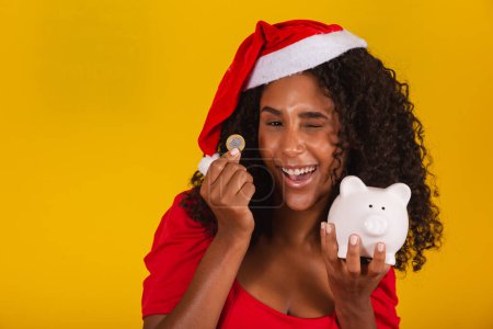 Photo for Beautiful young woman making savings for Christmas. - Royalty Free Image