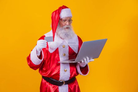 Photo for Santa Claus buying on line. Santa Claus buying on line - Royalty Free Image