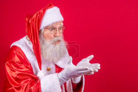 Photo for Merry Christmas and Happy Holidays! Santa Claus blows snow. - Royalty Free Image