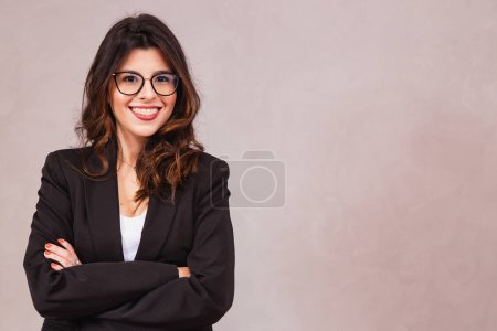 Photo for Smiling brunette woman without glasses posing with arms crossed and looking at camera. - Royalty Free Image