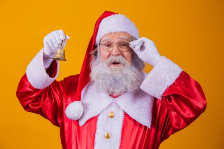 Photo for Santa Claus ringing a small bell. Jingle Bells. Savings on purchases. Christmas is coming. Preparing for the Christmas night. Sales promotion. - Royalty Free Image
