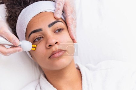 Foto de Mujer aplicando chorro de plasma en su cara - Imagen libre de derechos