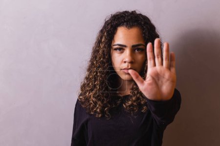 Photo for Confident black woman protesting against racial discrimination isolated on yellow background - Young diverse african woman showing black lives matter gesture - stop racism, human rights concept - Royalty Free Image