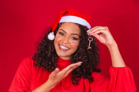 Photo for Christmas Girl In Santa Hat Holding House Keys Isolated. - Royalty Free Image