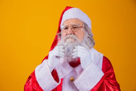 Photo for Santa Claus touching his long white beard. - Royalty Free Image