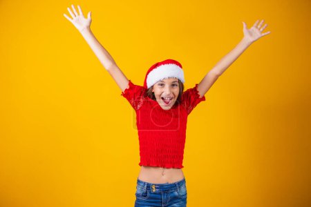 girl with arms up in christmas outfit