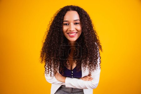 Photo for Young afro business woman with arms crossed smiling looking at camera. - Royalty Free Image