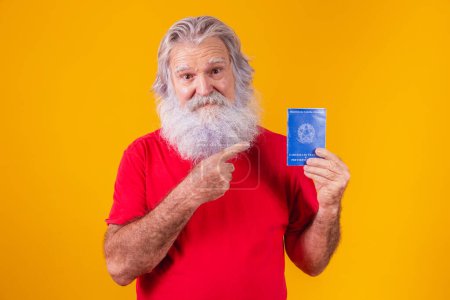 Photo for Senior bearded teenager holding a Brazilian work card - Royalty Free Image