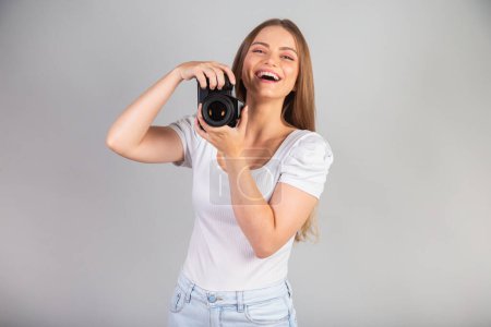 Photo for Blonde Brazilian woman with camera in hand. - Royalty Free Image