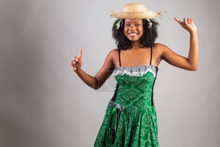 Photo for Portrait, Black Brazilian woman in festa junina clothes. Saint John's festival. dancing. - Royalty Free Image